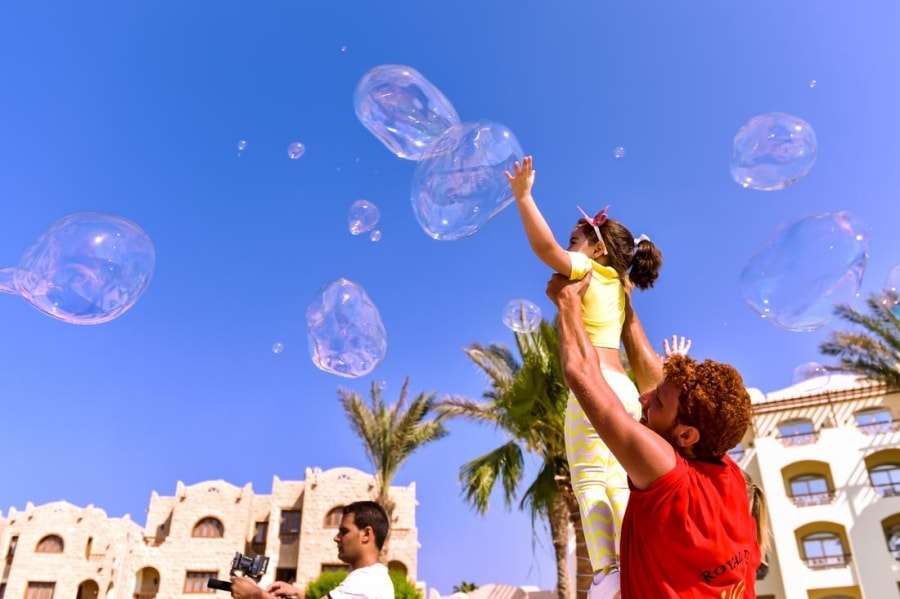 Девочка ловит мыльные пузыри